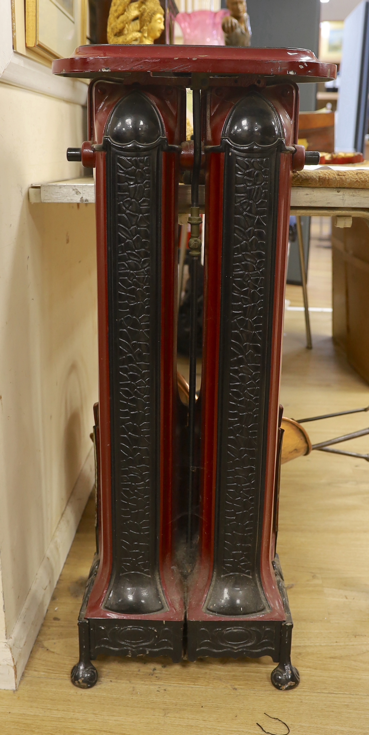 A maroon and black enamel Cannon Hilston heater, 95cm high, 39cm wide